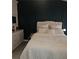 Serene bedroom with a large bed, dark accent wall, and dresser, creating a relaxing atmosphere at 6620 Wellington Sq, Norcross, GA 30093