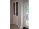 Hallway closet with white doors and nearby door with window, perfect for storage at 6620 Wellington Sq, Norcross, GA 30093