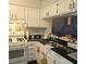 Functional kitchen with white cabinets, black countertops, and a gas stove for easy cooking at 6620 Wellington Sq, Norcross, GA 30093