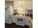 Practical kitchen featuring white appliances, ample cabinet space, and a convenient layout for meal prep at 6620 Wellington Sq, Norcross, GA 30093