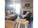 Inviting living room features a neutral sofa, fireplace, and bright window with sheer curtains at 6620 Wellington Sq, Norcross, GA 30093