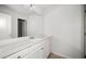 Bathroom featuring a long white countertop, cabinets and a large mirror at 3016 Creekside Overlook Way, Austell, GA 30168