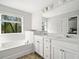 Bathroom with double vanity, soaking tub and window at 3016 Creekside Overlook Way, Austell, GA 30168