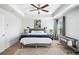 Primary bedroom featuring a ceiling fan, tray ceilings, ensuite bathroom, and ample natural light at 3016 Creekside Overlook Way, Austell, GA 30168