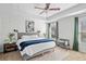 Primary bedroom featuring a ceiling fan, tray ceilings, ensuite bathroom, and ample natural light at 3016 Creekside Overlook Way, Austell, GA 30168