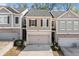 Charming townhome featuring a two-car garage and classic shutters at 3016 Creekside Overlook Way, Austell, GA 30168