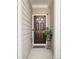 Inviting front door with neutral siding, potted plant, and welcome mat at 3016 Creekside Overlook Way, Austell, GA 30168