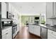 Modern, streamlined kitchen leading into the dining and living areas, promoting a spacious feel at 3016 Creekside Overlook Way, Austell, GA 30168