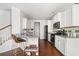 Efficient kitchen features a breakfast bar, stainless steel appliances, granite countertops, and white cabinetry at 3016 Creekside Overlook Way, Austell, GA 30168