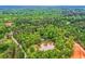Aerial view showcasing the house surrounded by a pond, trees, and natural landscapes at 5419 Tyree Rd, Winston, GA 30187