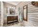 Charming rustic bathroom with shiplap walls, stone tile floors, and decorative vanity at 5419 Tyree Rd, Winston, GA 30187