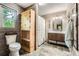 Rustic bathroom with weathered wood paneling, built-in shelving, and a modern vanity at 5419 Tyree Rd, Winston, GA 30187