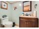 Charming powder room with wooden accents and a vintage-inspired vanity, creating a cozy and unique space at 5419 Tyree Rd, Winston, GA 30187