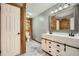 Stylish bathroom featuring a dual sink vanity, custom mirror, and wood accent walls at 5419 Tyree Rd, Winston, GA 30187