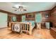 Wood-clad bedroom with rustic log bed, wood floors, and plenty of natural light from multiple windows at 5419 Tyree Rd, Winston, GA 30187