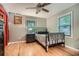 Cozy bedroom featuring hardwood floors, soft gray walls, and natural light from windows at 5419 Tyree Rd, Winston, GA 30187