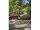 A view of a long private driveway, bordered by a rustic black fence and lush greenery at 5419 Tyree Rd, Winston, GA 30187