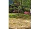 Exterior of home surrounded by mature trees and lush landscaping at 5419 Tyree Rd, Winston, GA 30187