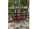 A rustic black fence enclosing the property with a vibrant red azalea bush in front at 5419 Tyree Rd, Winston, GA 30187