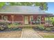 Inviting cottage-style home with metal roof, a covered porch and a stone pathway to the front door at 5419 Tyree Rd, Winston, GA 30187