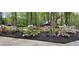 Beautifully landscaped front yard with blooming azaleas and decorative garden accents at 5419 Tyree Rd, Winston, GA 30187