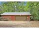 Exterior features a spacious garage with metal roof, storage, and covered area for equipment at 5419 Tyree Rd, Winston, GA 30187