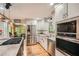 Well-lit kitchen with granite countertops, stainless steel appliances, and a breakfast bar at 5419 Tyree Rd, Winston, GA 30187