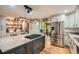 Spacious kitchen featuring a large island, stainless steel appliances, and farmhouse-style decor at 5419 Tyree Rd, Winston, GA 30187