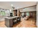 Open-concept living space with a kitchen island, and a cozy fireplace and living room area at 5419 Tyree Rd, Winston, GA 30187