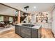 Open concept living room and kitchen featuring wood beams, an island and rustic furniture at 5419 Tyree Rd, Winston, GA 30187
