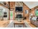 Inviting living room with a stone fireplace, wood paneling and lots of natural light at 5419 Tyree Rd, Winston, GA 30187