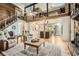 Living room featuring hardwood floors, stone fireplace, wood paneling, and loft at 5419 Tyree Rd, Winston, GA 30187