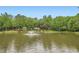 Wide view of a serene pond with a fountain, surrounded by trees, offering a peaceful and picturesque setting at 5419 Tyree Rd, Winston, GA 30187