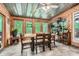 Charming sunroom with wood paneling, rustic furniture and views of the surrounding trees at 5419 Tyree Rd, Winston, GA 30187