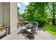 Inviting outdoor back deck area with a dining table, grill, and lush green landscaping at 7048 Bennington Ln, Cumming, GA 30041