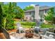 Charming backyard patio with a fire pit and Adirondack chairs, perfect for outdoor relaxation at 7048 Bennington Ln, Cumming, GA 30041