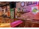 Custom bar area with a unique bottle cap epoxy countertop and exposed brick at 7048 Bennington Ln, Cumming, GA 30041