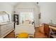 Bright bedroom with a white bed frame, neutral walls, hardwood floors and lots of natural light at 7048 Bennington Ln, Cumming, GA 30041