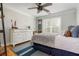 Cozy bedroom with a comfortable bed, dresser, wood floors, and a ceiling fan for added comfort at 7048 Bennington Ln, Cumming, GA 30041
