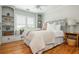 Bright bedroom with hardwood floors, built-in shelves, window seat, and decorative headboard at 7048 Bennington Ln, Cumming, GA 30041
