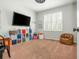 Bedroom with window and carpeted floors; storage and colorful cube shelves at 7048 Bennington Ln, Cumming, GA 30041