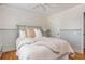 Cozy bedroom featuring wood floors, beadboard paneling, and a unique headboard design at 7048 Bennington Ln, Cumming, GA 30041