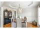 Elegant dining room featuring hardwood floors, a stylish chandelier, and wainscoting at 7048 Bennington Ln, Cumming, GA 30041