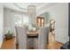 Dining room featuring decorative chandelier, hardwood floors, and arched doorway at 7048 Bennington Ln, Cumming, GA 30041