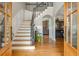 Grand foyer with hardwood floors, staircase with iron railings, and an open view to the living spaces at 7048 Bennington Ln, Cumming, GA 30041