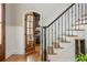 Stylish foyer features hardwood floors, staircase with iron railings, and access to a cozy study at 7048 Bennington Ln, Cumming, GA 30041