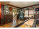 Finished basement area with a shuffleboard table, pinball machine and eclectic decor at 7048 Bennington Ln, Cumming, GA 30041