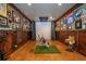 Indoor golf simulator room with custom wall decor, simulating a realistic golf experience at 7048 Bennington Ln, Cumming, GA 30041