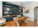 Charming home office with custom shelving, wood floors and large work space at 7048 Bennington Ln, Cumming, GA 30041