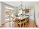 Stylish kitchen featuring white cabinets, modern appliances, a center island with marble countertop, and french doors to patio at 7048 Bennington Ln, Cumming, GA 30041